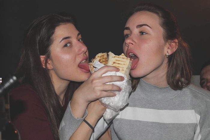 Девушки фотографируются с шаурмой